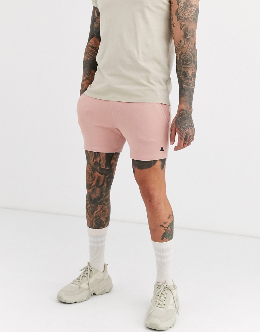 ASOS DESIGN - Kortse jersey skinny shorts in roze met driehoek