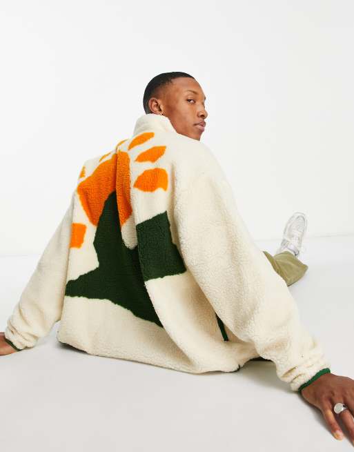 ASOS DESIGN – Kremowa kurtka oversize z kożuszka z zapięciem na zamek i motywem słońca na plecach