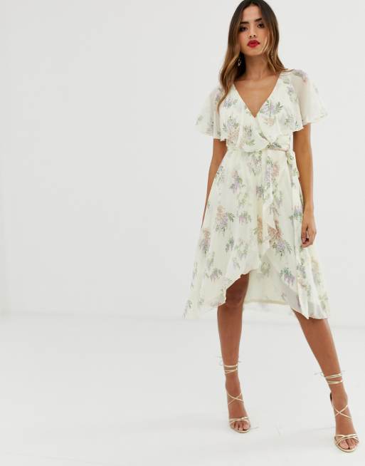 ASOS DESIGN – Kremowa sukienka midi z pelerynką z tyłu i obniżonym dołem w  kwiaty | ASOS