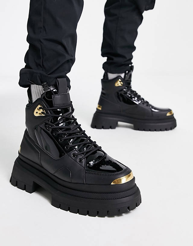 ASOS DESIGN - lace up boot in black faux leather with gold detail on chunky sole