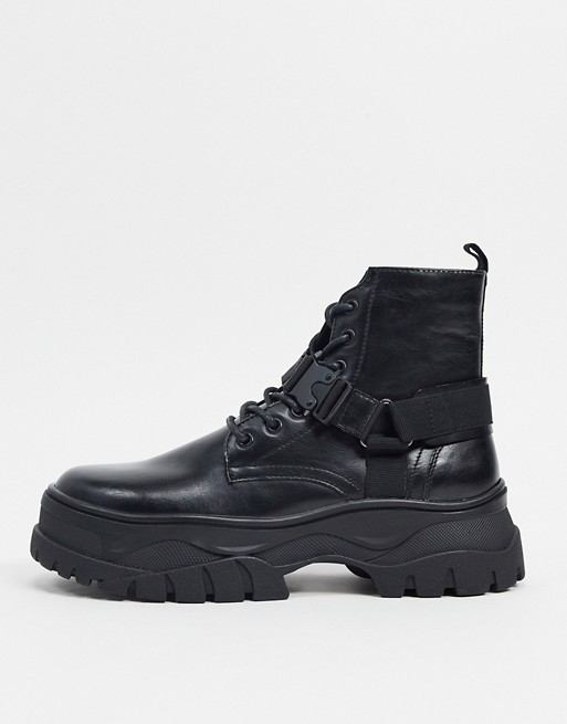 ASOS DESIGN lace up boots in black faux leather with strap detail on chunky sole