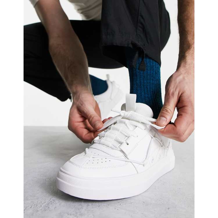 ASOS DESIGN lace-up sneakers in white with embossed monogram