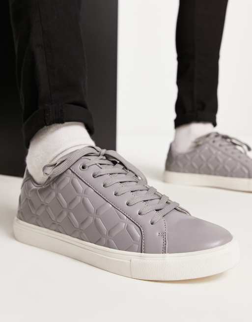 ASOS DESIGN lace-up sneakers in white with embossed monogram