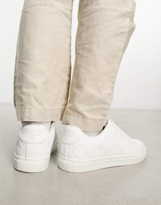 ASOS DESIGN lace-up sneakers in white with embossed monogram