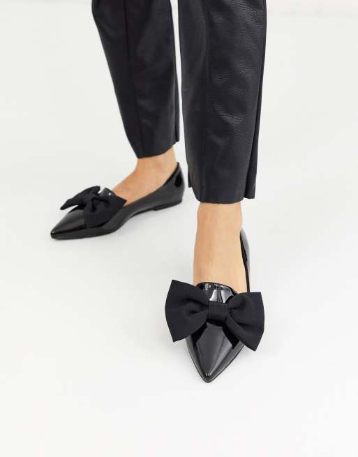 Black flats with outlet bows