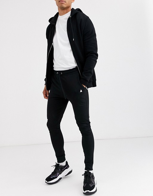 ASOS DESIGN lightweight super skinny joggers in black with triangle
