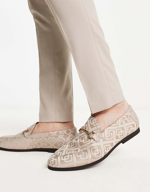 ASOS DESIGN loafers in brown monogram design with gold snaffle