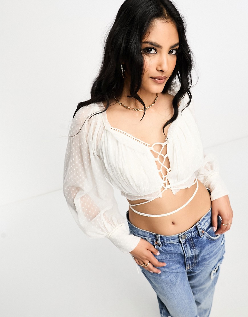 ASOS DESIGN long sleeve dobby crop top with lace up front and frill detail in ivory-White