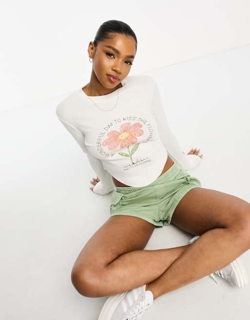 ASOS DESIGN long sleeve rib baby tee with curved hem positive flower graphic in cream
