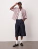 ASOS DESIGN longer length denim jorts in acid wash with pleat details