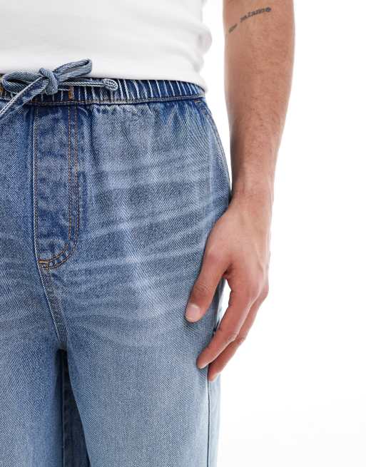 ASOS DESIGN longer length denim jorts in mid wash blue with cargo pocket details