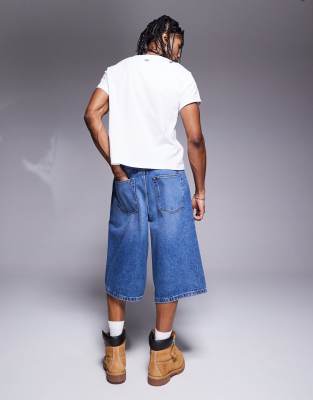 ASOS DESIGN longer length denim jort in mid wash blue