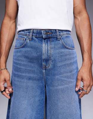 ASOS DESIGN longer length denim jort in mid wash blue