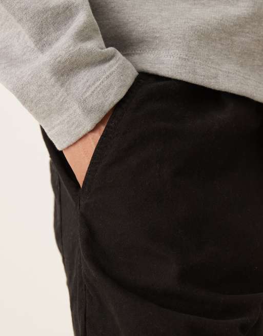 ASOS DESIGN longer length pleated shorts with belt in black