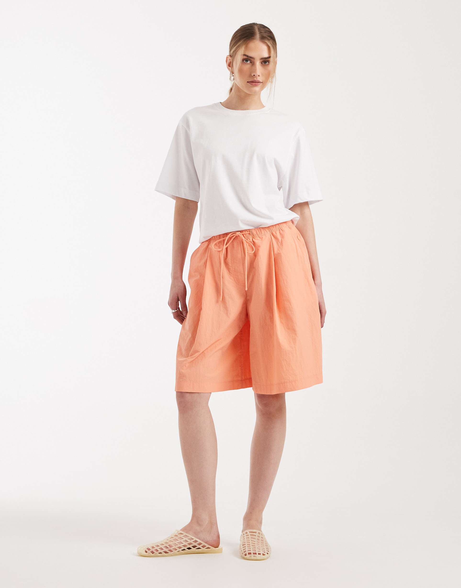 asos design longline shorts in techy fabric in coral