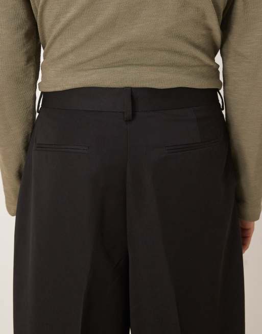ASOS DESIGN loose leg pleated dress pants with exposed button in black