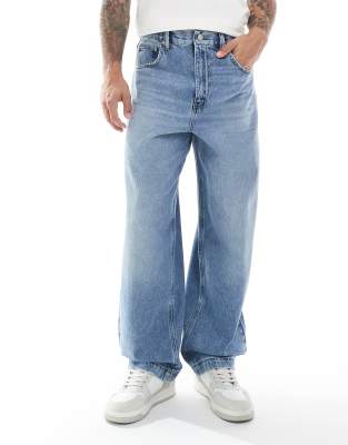 ASOS DESIGN loose straight jeans in midwash blue - view 1