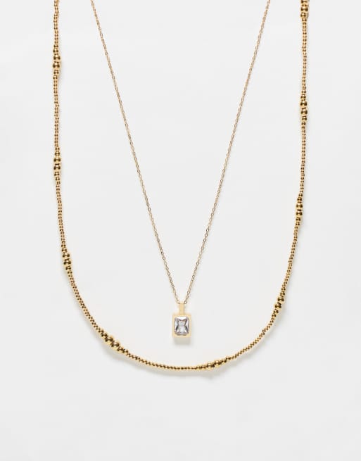 ASOS DESIGN - Lot de 2 colliers de perles en acier inoxydable avec pendentif à strass - Doré
