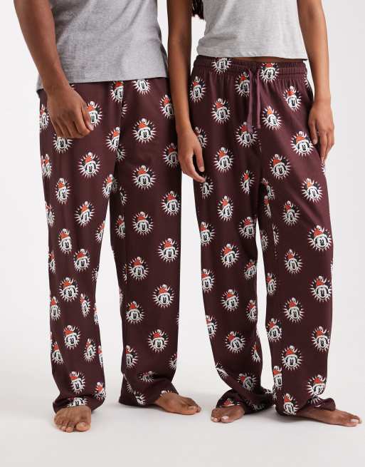 ASOS DESIGN lounge bottoms with Disney's Christmas Mickey Mouse graphics in burgundy