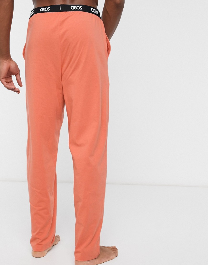 ASOS DESIGN Lounge - Pantaloni del pigiama arancioni con logo in vita-Arancione
