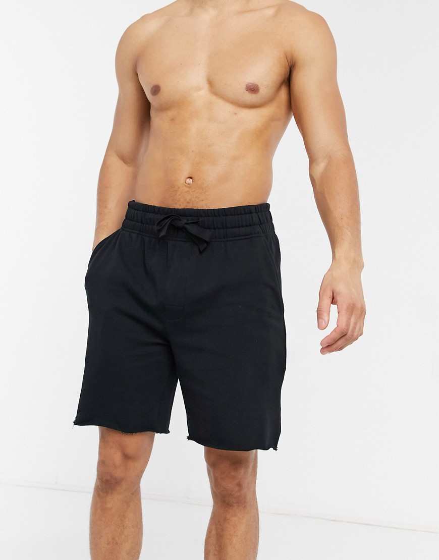 ASOS DESIGN lounge relaxed jersey shorts with raw hem in black