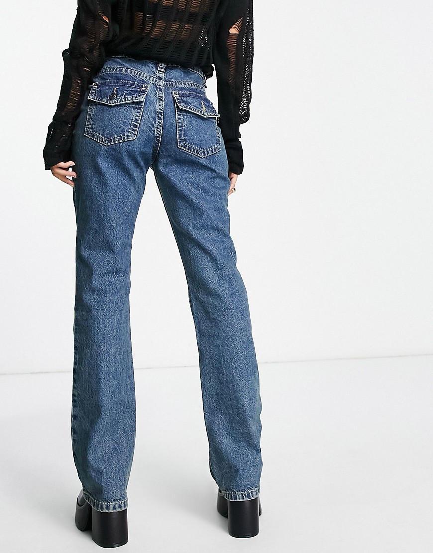 ASOS DESIGN low rise flared jeans with western pocket detail in tinted blue