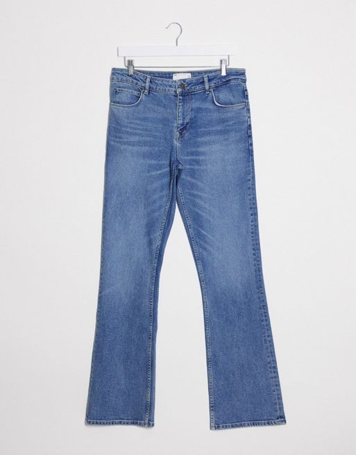 ASOS DESIGN low rise flare jean with belt in mid wash blue