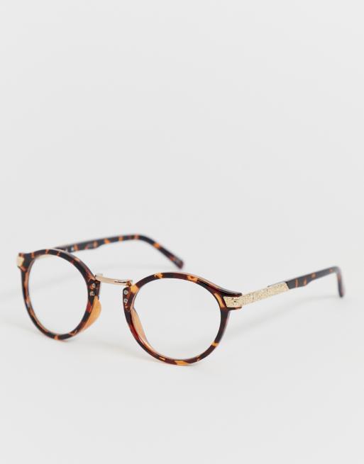ASOS DESIGN Lunettes tendance rondes en écaille de tortue avec verres transparents ASOS DESIGN Lunettes tendance rondes en écaille de tortue avec verres transparents