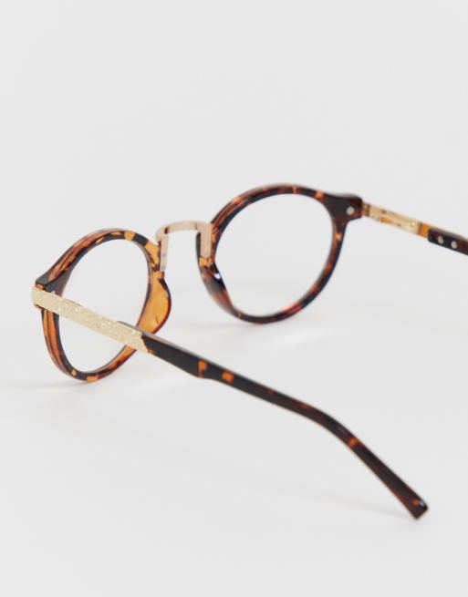 ASOS DESIGN Lunettes tendance rondes en écaille de tortue avec verres transparents ASOS DESIGN Lunettes tendance rondes en écaille de tortue avec verres transparents