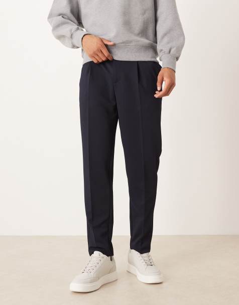 ASOS DESIGN – Marinblå, figursydda, avsmalnande byxor med elastisk midja - view 1