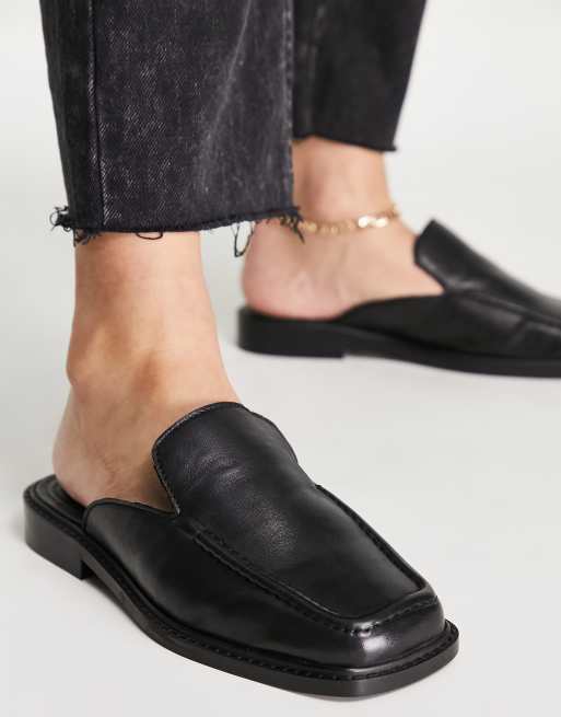 Black leather store mules flat