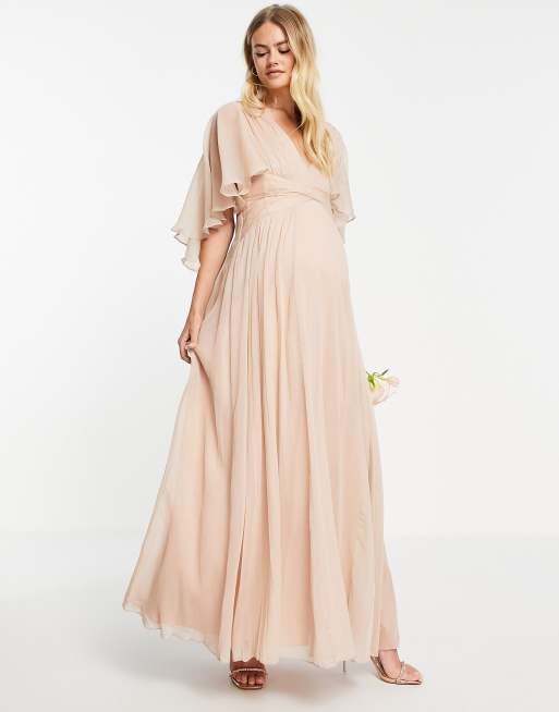 ASOS DESIGN Maternity Bridesmaid ruched bodice drape maxi dress with wrap waist and flutter cape sleeve in blush