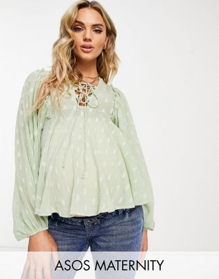 ASOS DESIGN Maternity dobby long sleeve blouse with lace up front & peplum hem in sage
