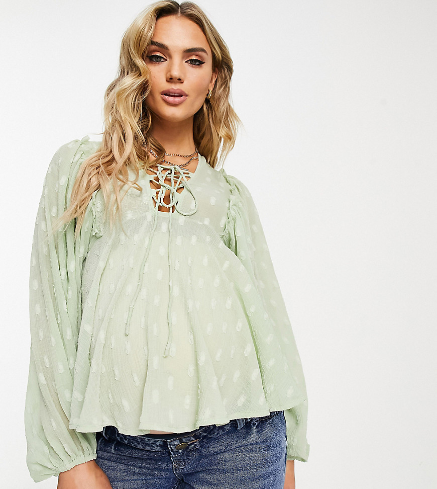 ASOS DESIGN Maternity dobby long sleeve blouse with lace up front & peplum hem in sage-Green