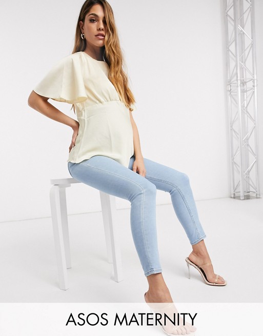 ASOS DESIGN Maternity high rise ridley 'skinny' jeans in bright lightwash blue with over bump waistband