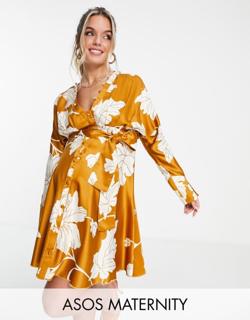 ASOS DESIGN Maternity satin batwing mini dress with button front detail and tie front in mustard floral print