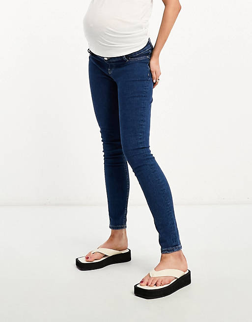 ASOS DESIGN Maternity skinny jeans in mid blue with over the bump waistband  | ASOS