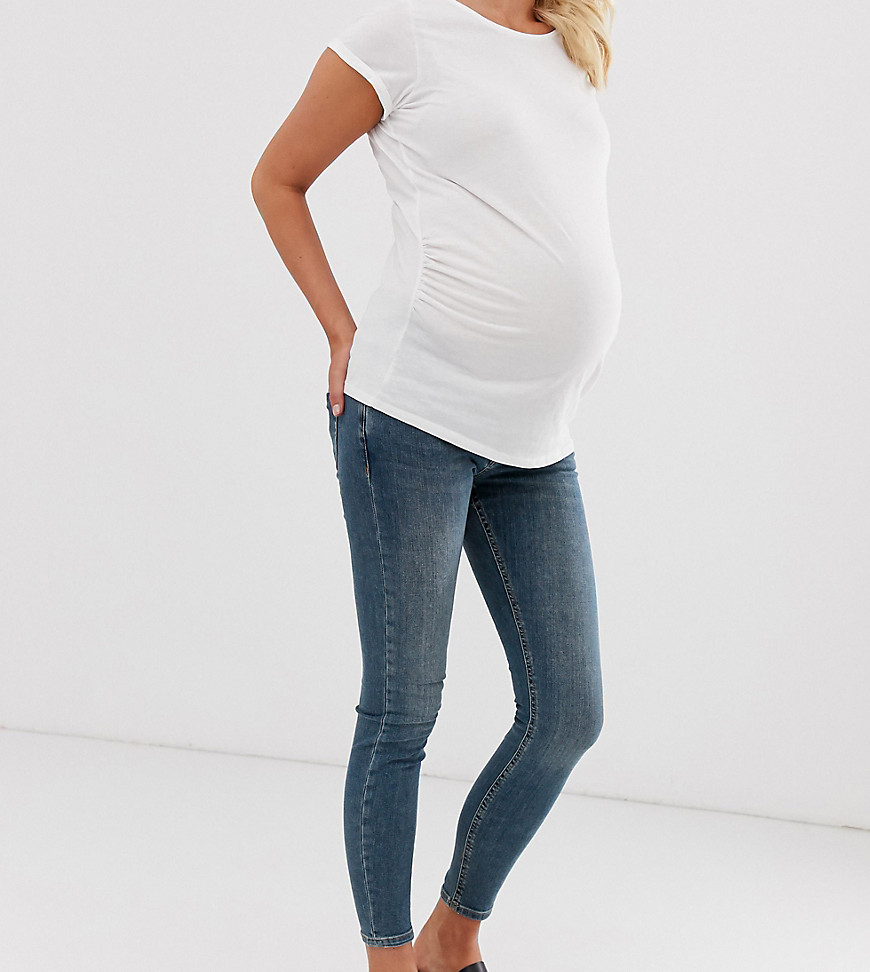 ASOS DESIGN Maternity - Whitby - Skinny jeans met lage taille, middenblauwe wassing en over de buik vallende tailleband