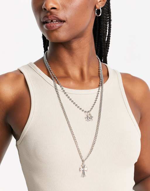 ASOS DESIGN - Meerlaagse lange ketting met kruisje en Franse lelie hangers in zilverkleur
