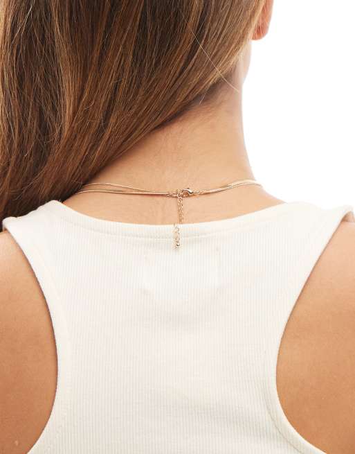 ASOS DESIGN – Mehrreihige, goldfarbene Halskette mit schwarzem Keramik-Anhänger, 2 von 3