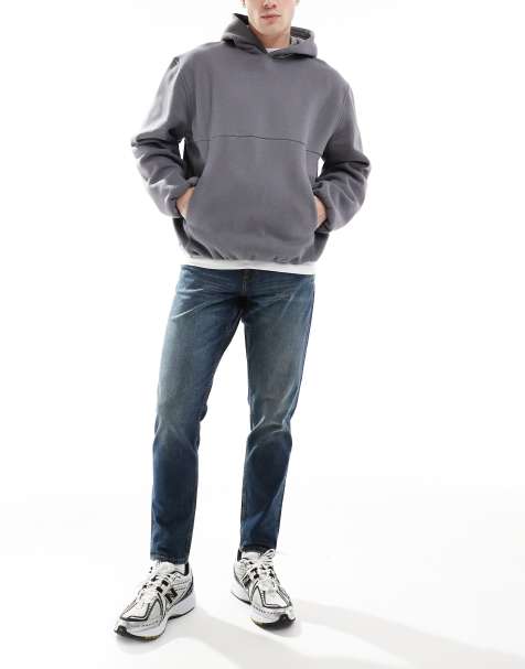 ASOS DESIGN - Mellemblå og forvaskede jeans med tapered pasform og stretch - view 1