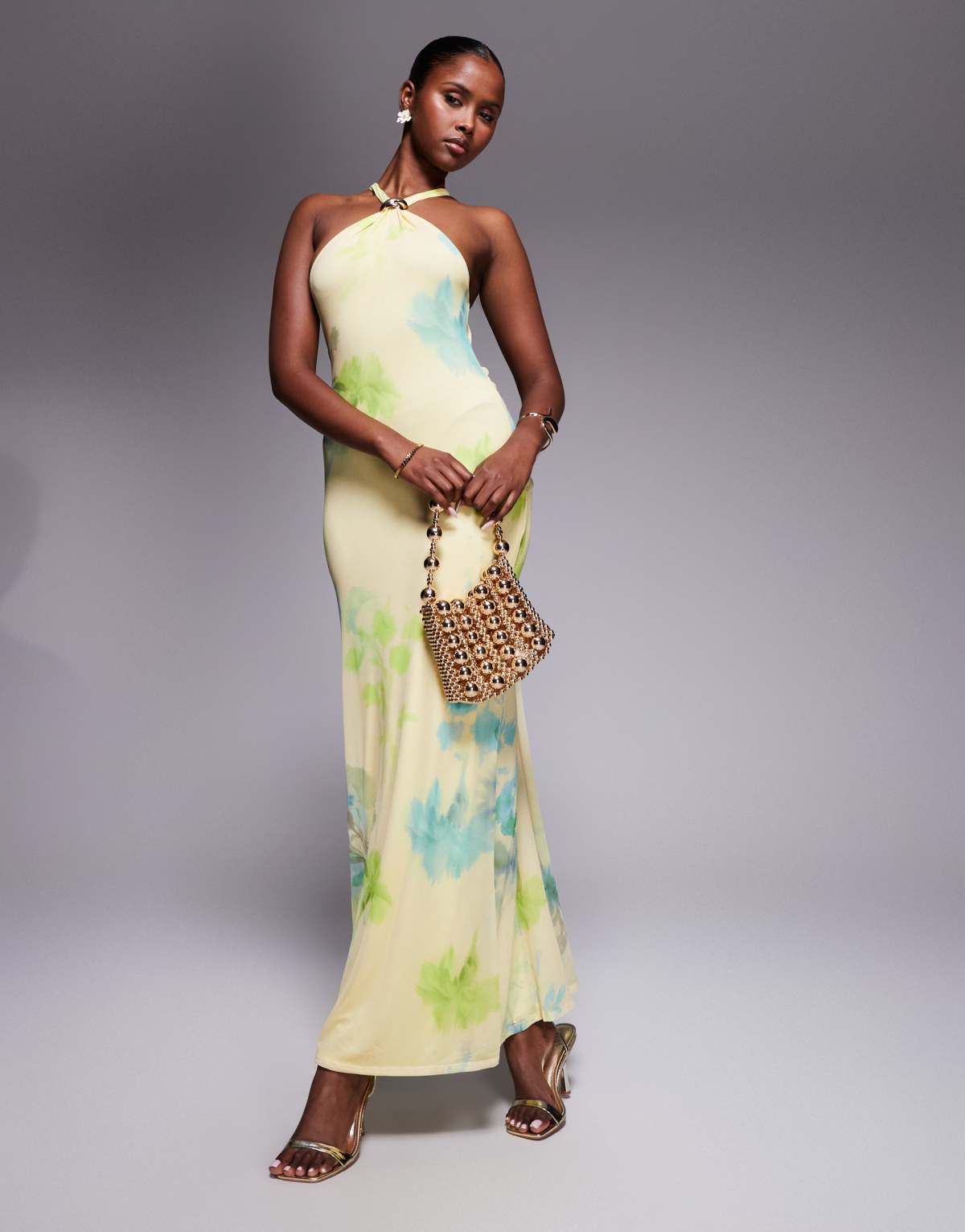 ASOS DESIGN mesh trimmed halterneck maxi dress with twisted back detail in yellow floral print