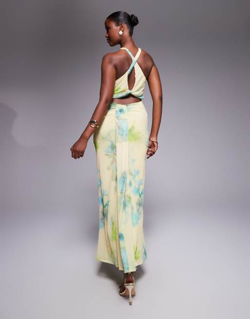 ASOS DESIGN mesh trimmed halterneck maxi dress with twisted back detail in yellow floral print