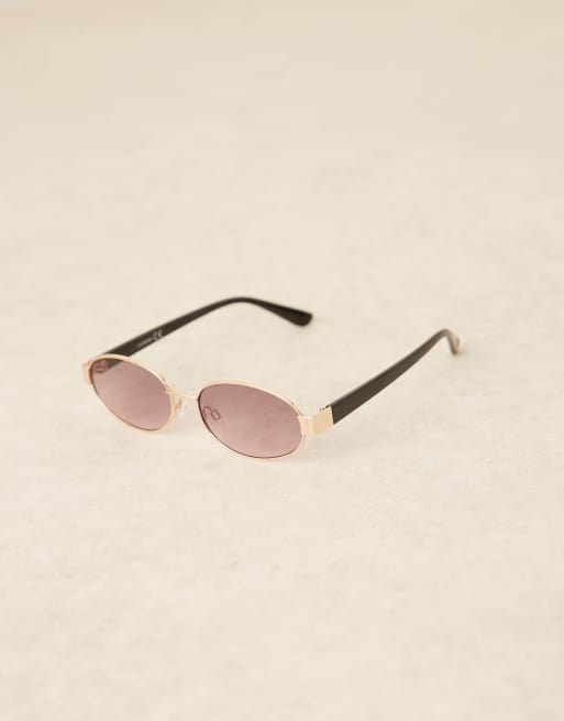 ASOS DESIGN metal oval sunglasses in gold with black arms | ASOS display picture 2