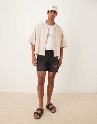 ASOS DESIGN mid length slim denim shorts with rips in black