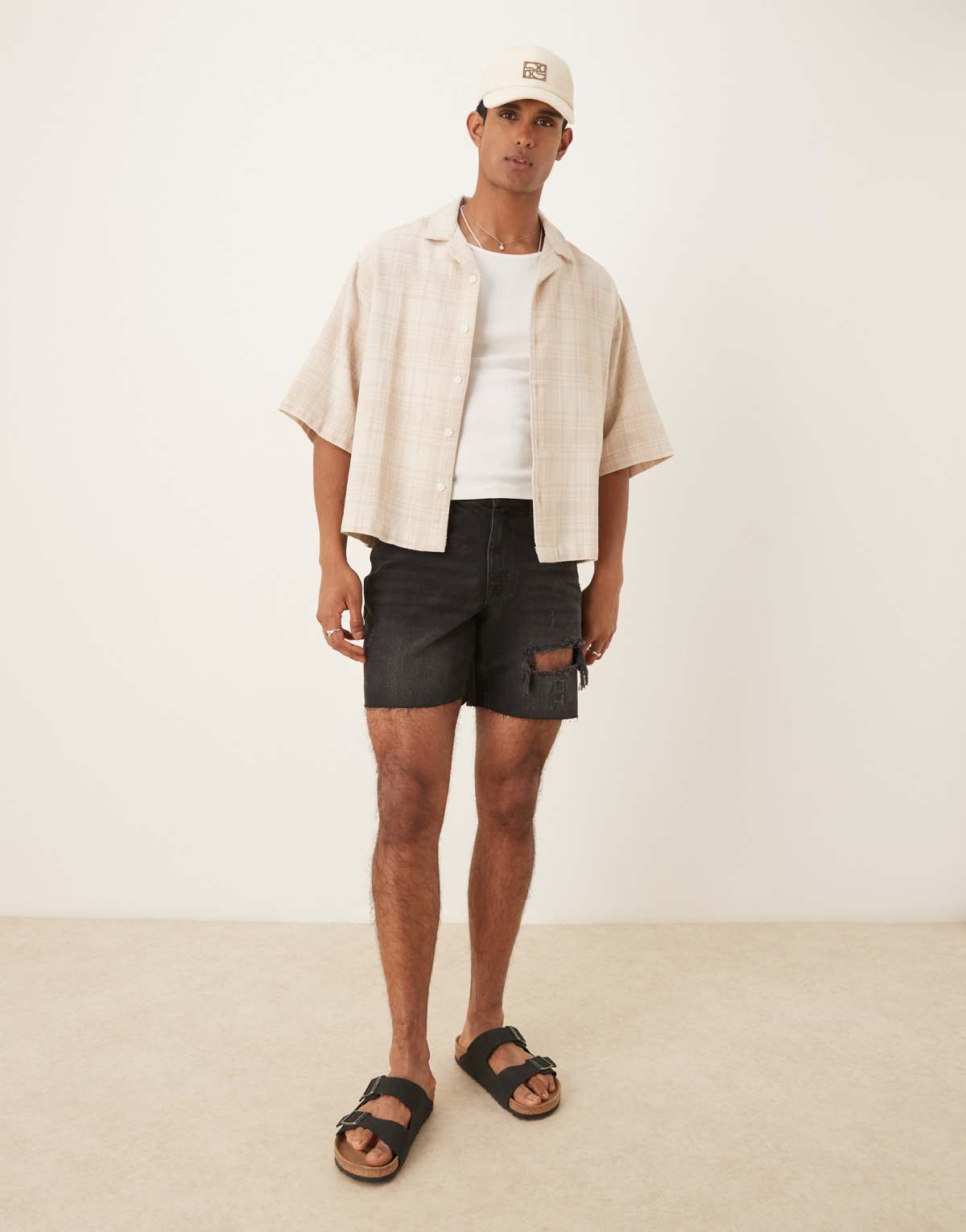 ASOS DESIGN mid length slim denim shorts with rips in black