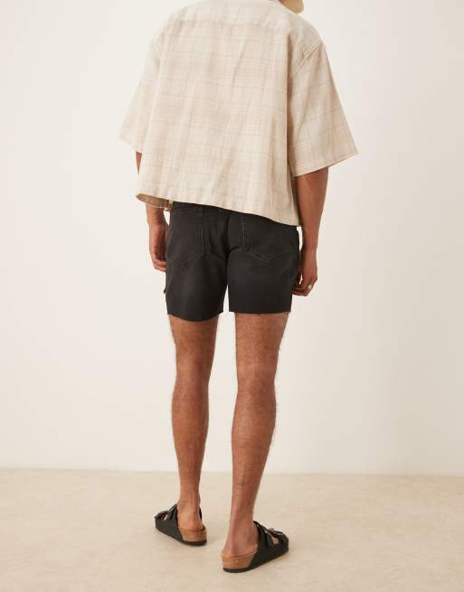 ASOS DESIGN mid length slim denim shorts with rips in black