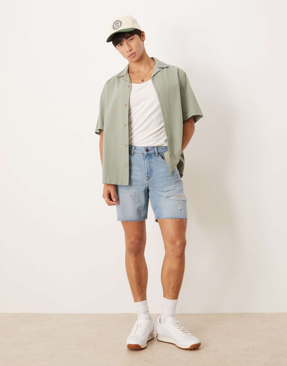 ASOS DESIGN mid length slim denim shorts with rips in light wash blue