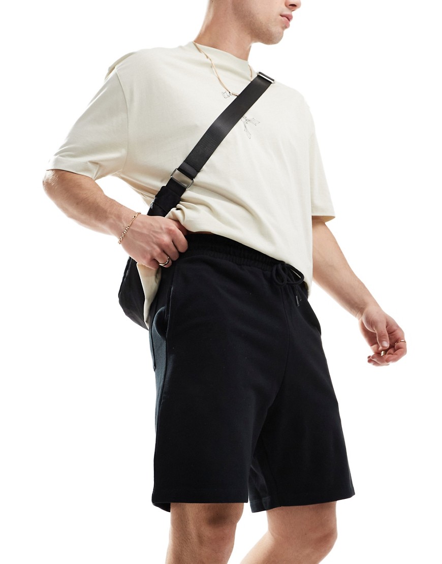 ASOS DESIGN mid length slim shorts in black
