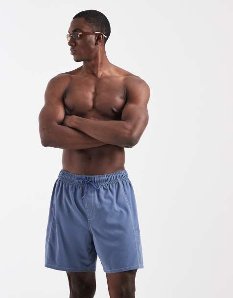 ASOS DESIGN mid length swim shorts with utility styling in blue with contrast stitch - view 1
